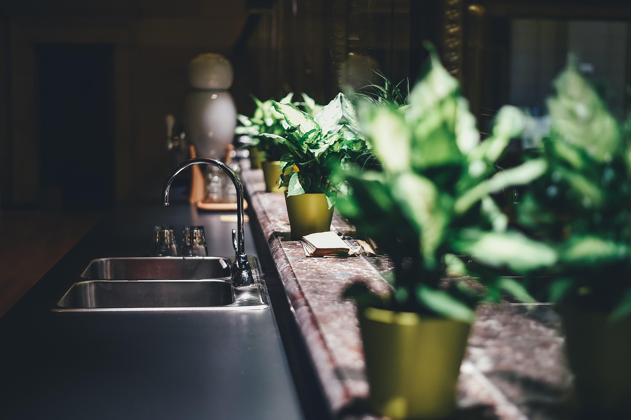 Kitchen sink with a chrome gooseneck tap in a dark modern kitchen